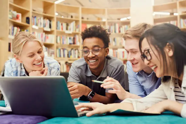 Students watching curious video on laptop