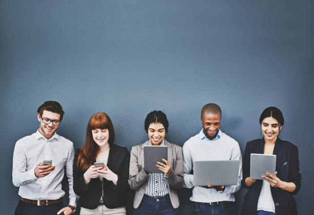 Studio shot of a group of people waiting in a line against a blue background