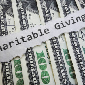 Charitable Contribution paper message on hundred dollar bills