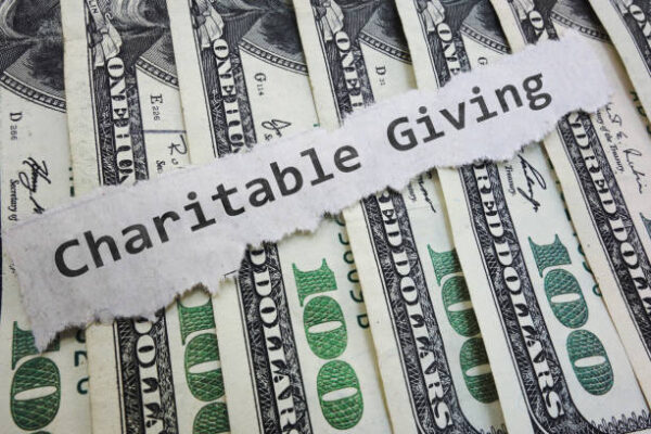 Charitable Contribution paper message on hundred dollar bills