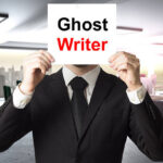 businessman in black suit hiding face behind sign ghost writer